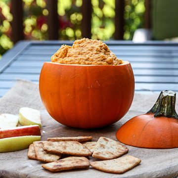 A tiny pumpkin filled with hummus