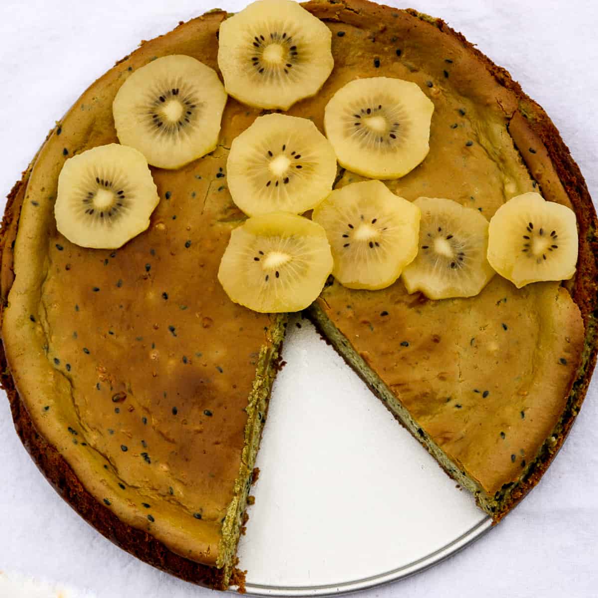 Matcha cheesecake topped with kiwi slices.