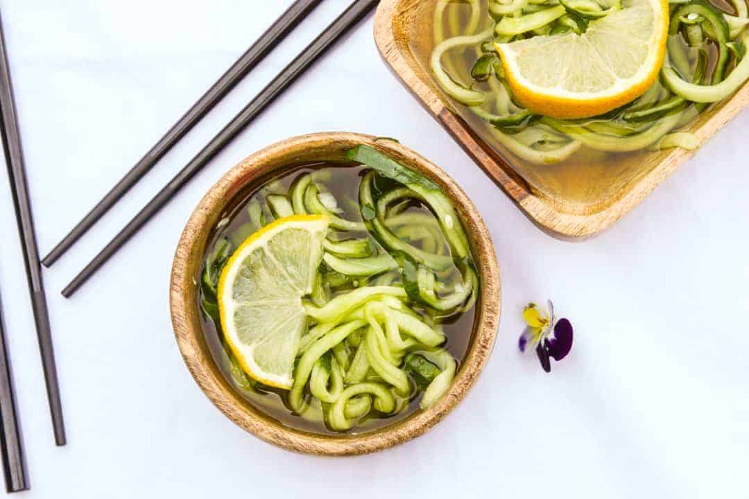cucumber noodles in a wooden bowl on a table