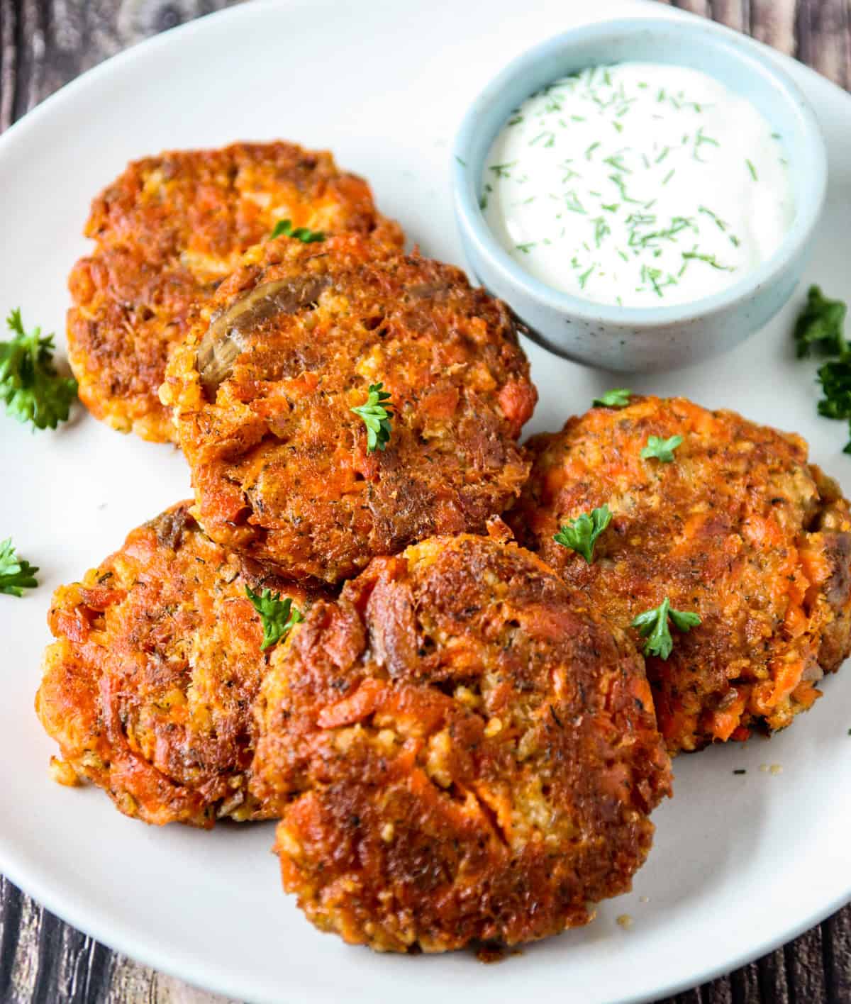 Old fashioned salmon patties on a white plate.