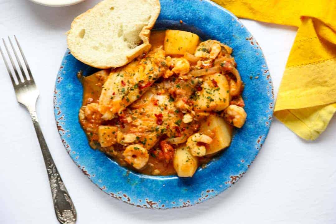 A plate of food, with Fish stew