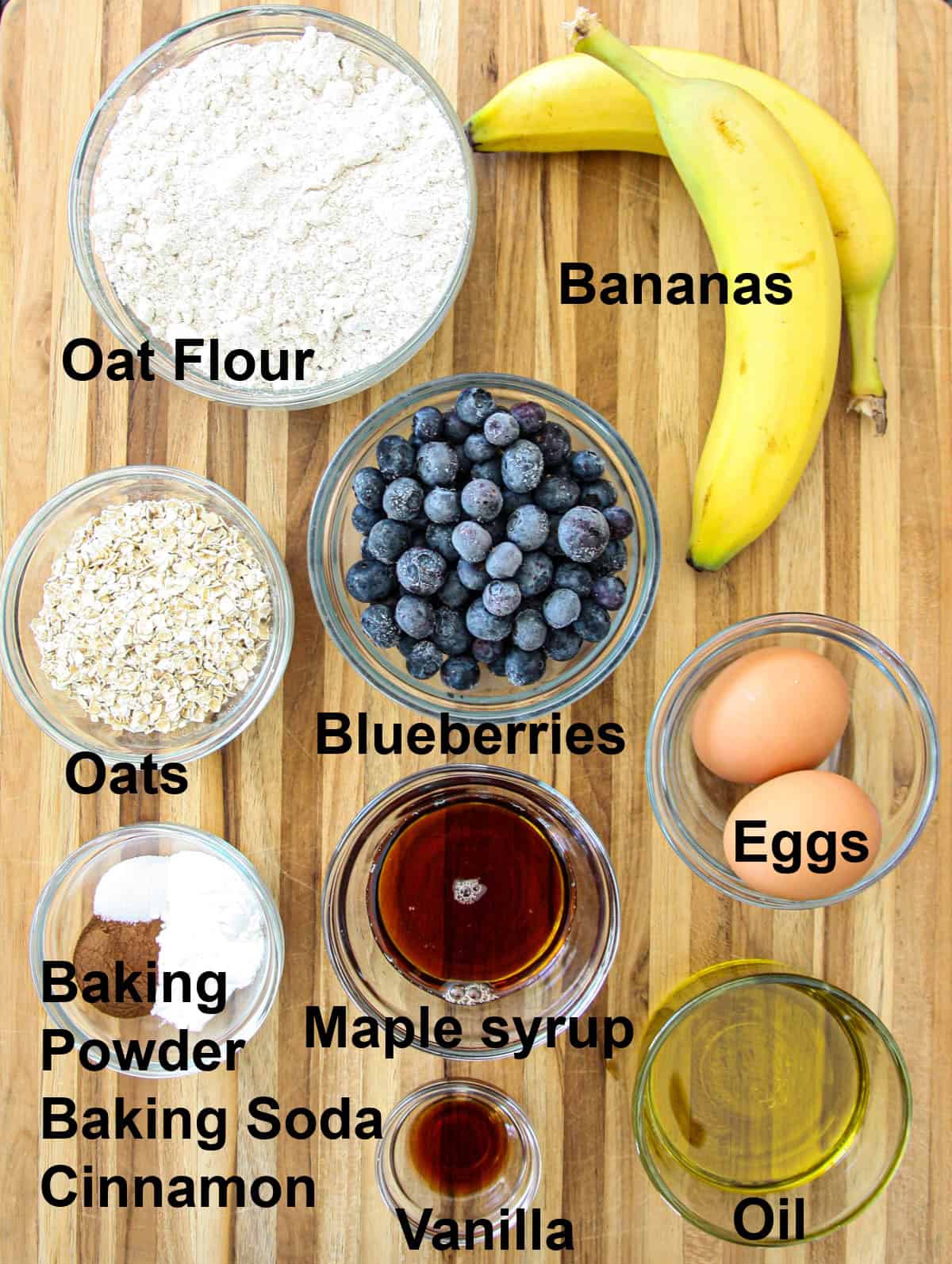 All of the ingredients needed to make this recipe in glass bowls on a wooden board.