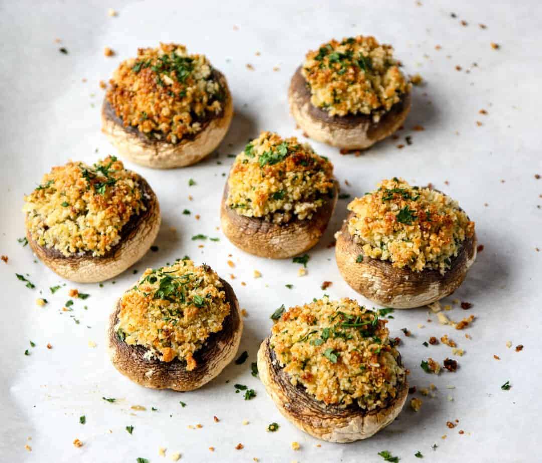 A plate of food, with Stuffed mushrooms