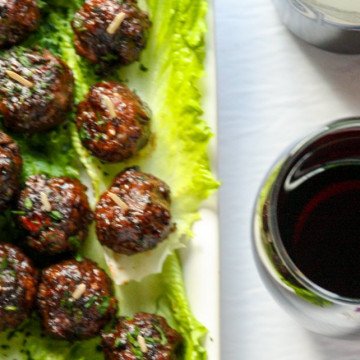 A plate of food and a glass of wine