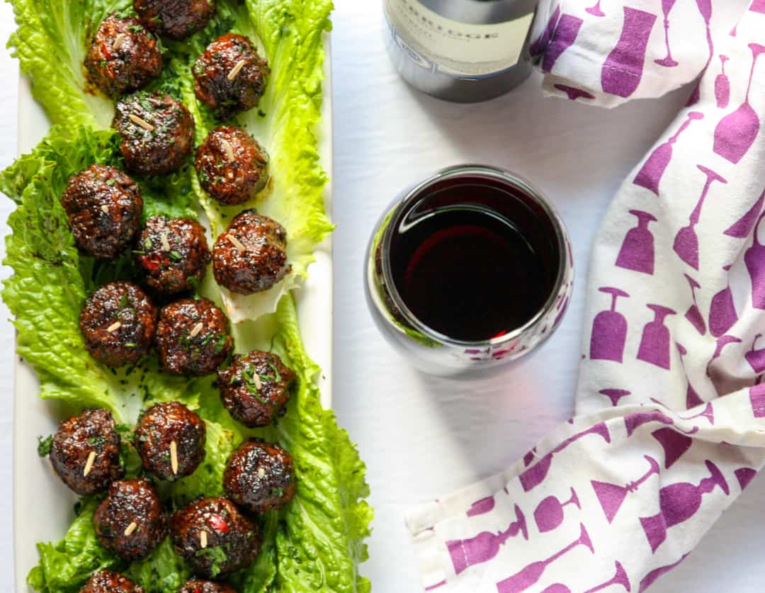 Merlot meatballs on a bed of lettuce.
