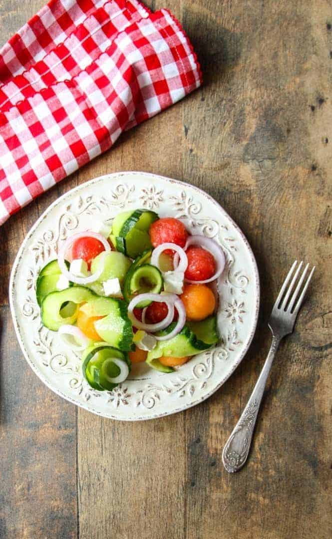 A plate of salad on a wooden table