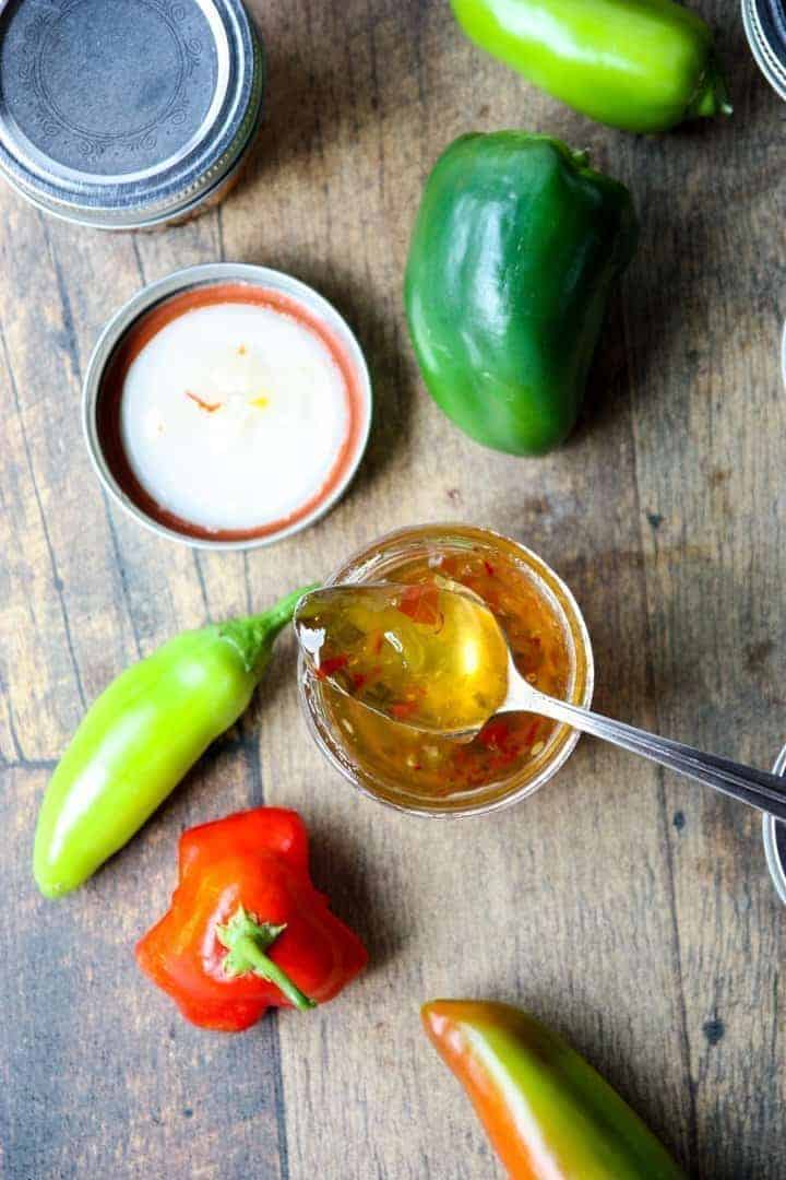 jar of pepper jelly with a spoon in it