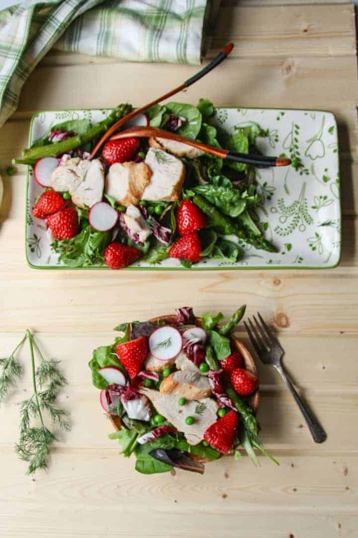 A plate of fresh fruit and vegetables on a cutting board