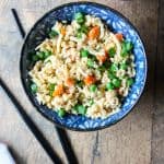 A bowl of food with rice and broccoli