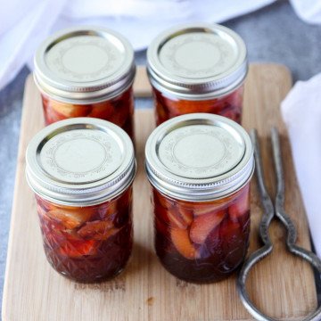 Four jars of pickles on a table