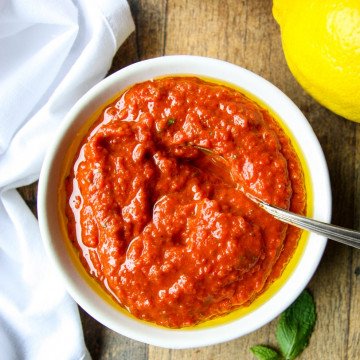 Harissa Paste in a white bowl with a spoon