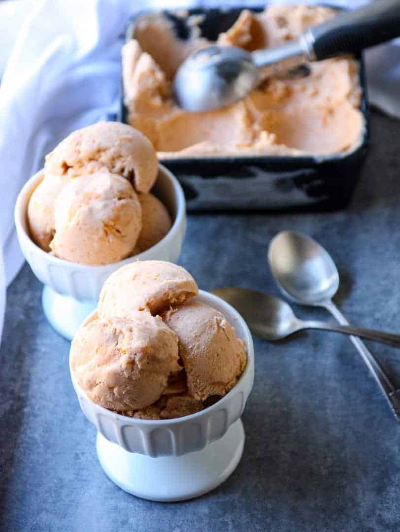 Two white dishes of Apricot Mascarpone Ice Cream