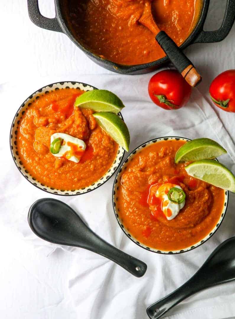 Two bowls of Pumpkin soup on a table