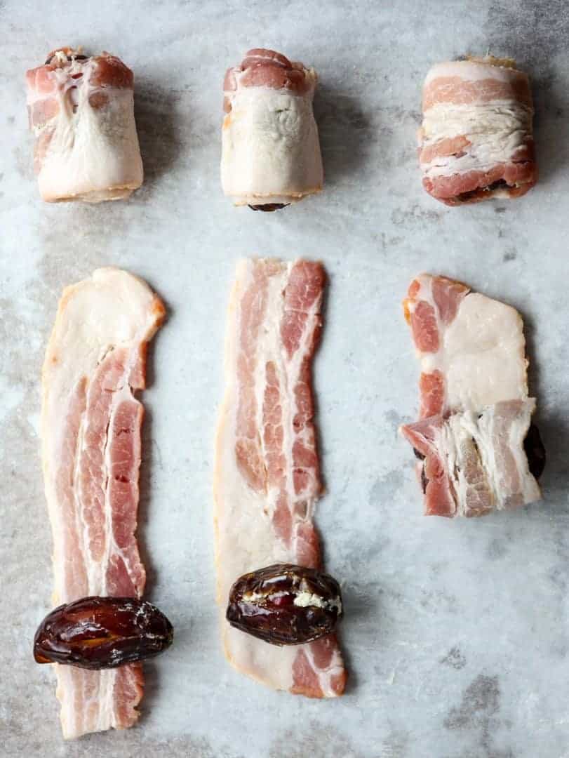 dates filled with cheese being wrapped in bacon slices