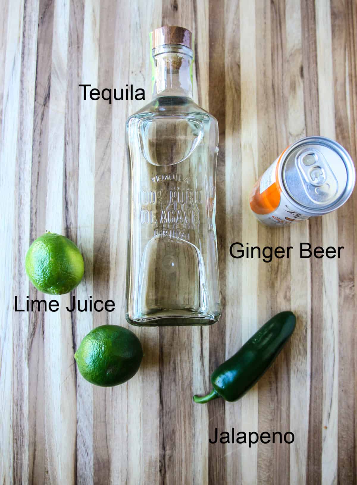 The ingredients to make this drink recipe laid out on a wooden board.