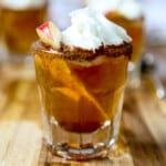 An apple pie shot garnished with an apple slice.