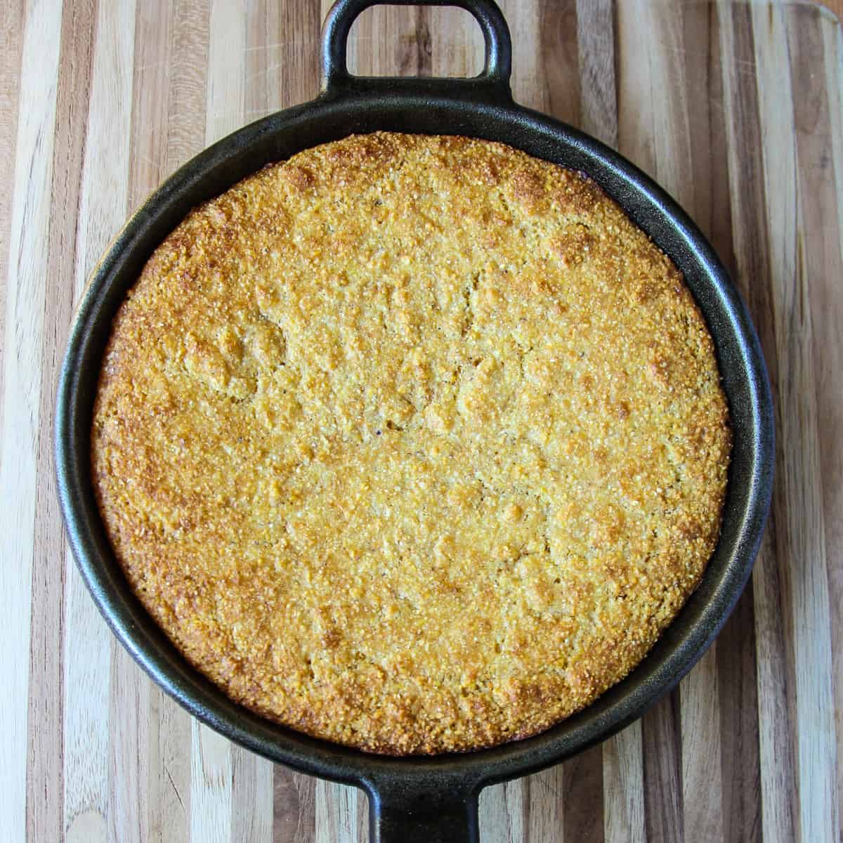 Baked cornbread in a cast iron skillet.