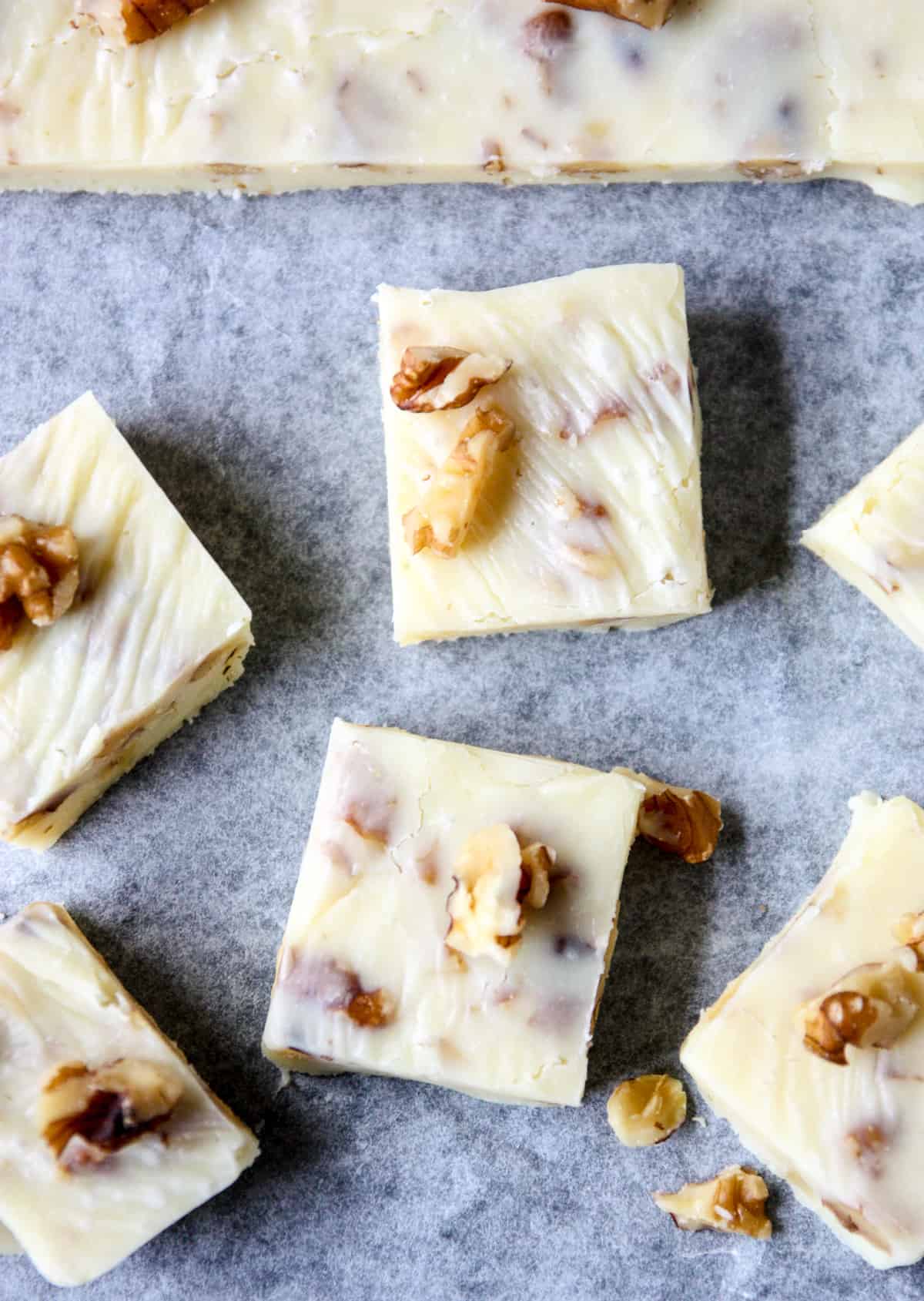 Pieces of maple fudge on parchment paper.
