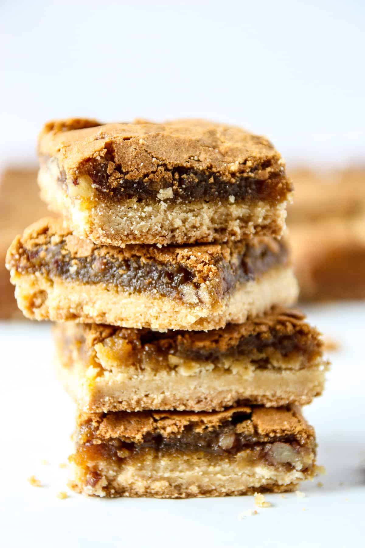 Four butter tart bars stacked.