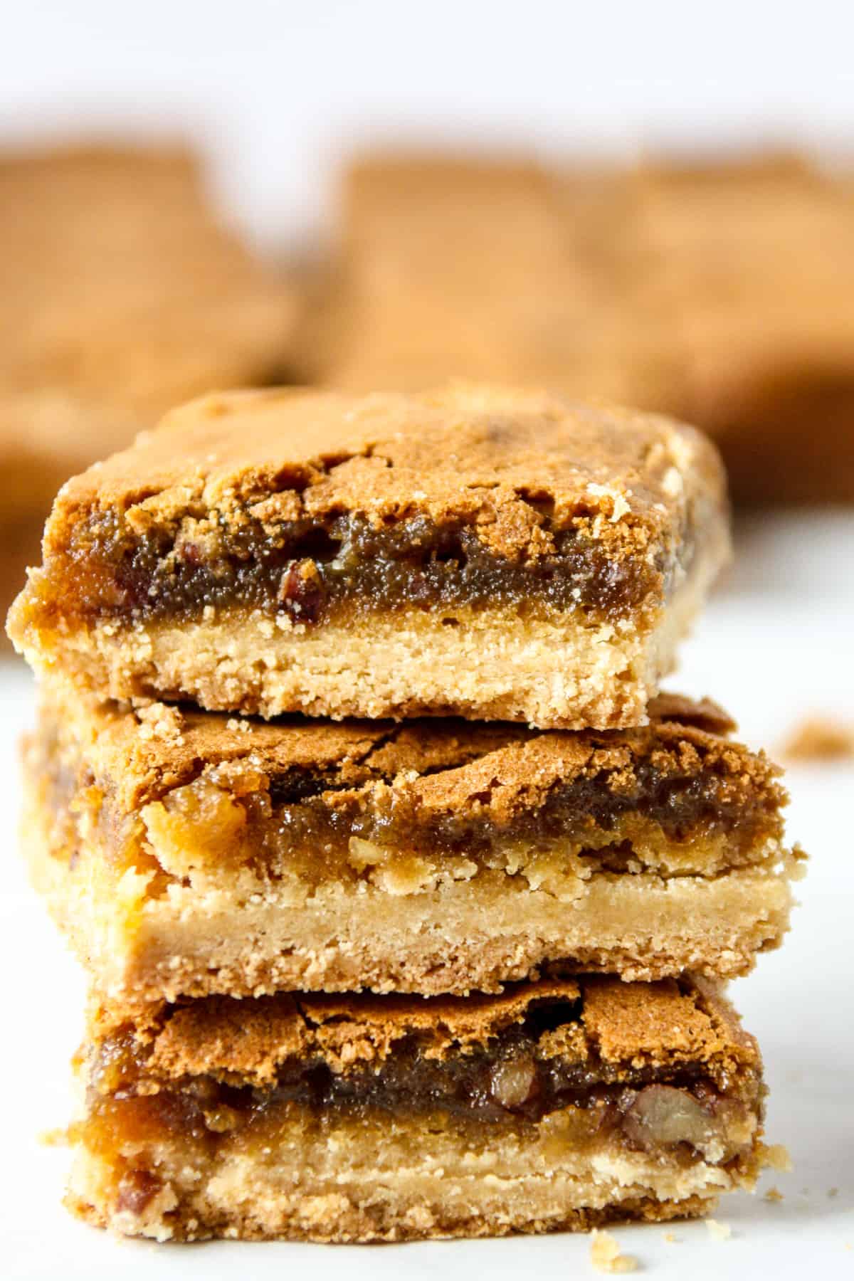 Three butter tart squares in a stack.