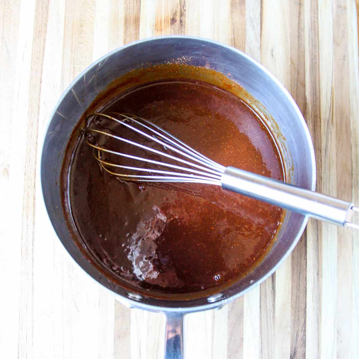 All of the ingredients combined with a whisk in a saucepan.