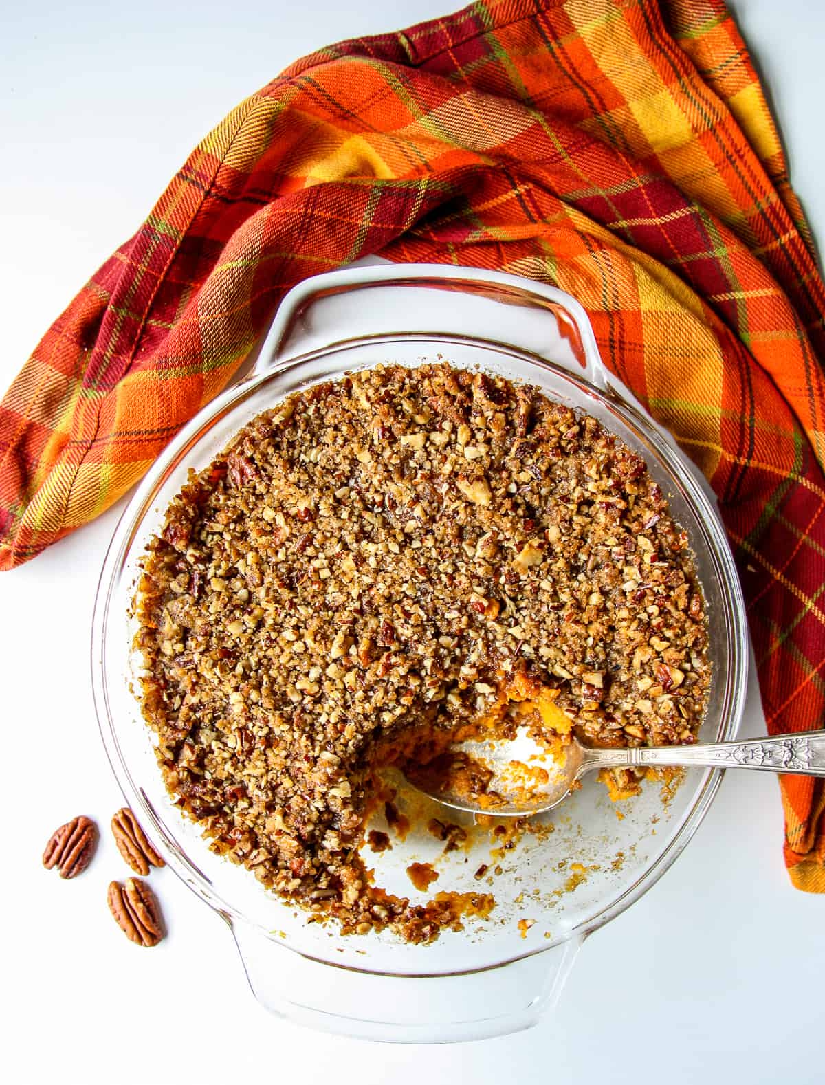 Baked sweet potato crunch casserole in a glass casserole dish.