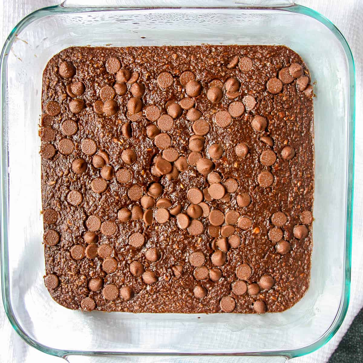 Chocolate baked oats in a square glass pan.