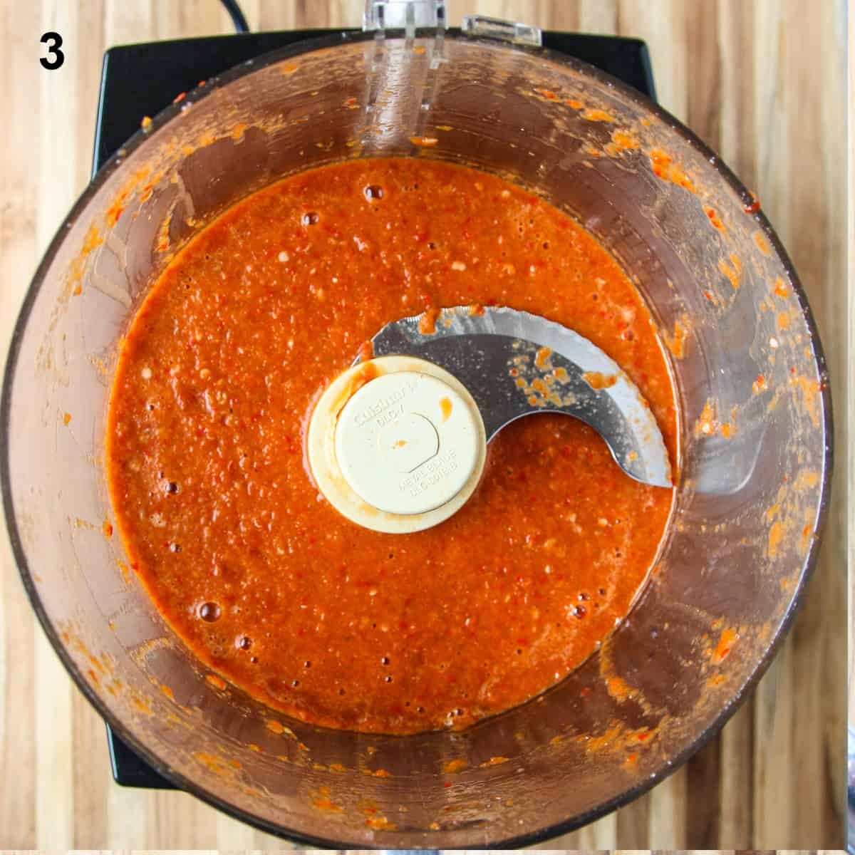 The cooked sauce in the food processor bowl after being processed to a smooth consistency.