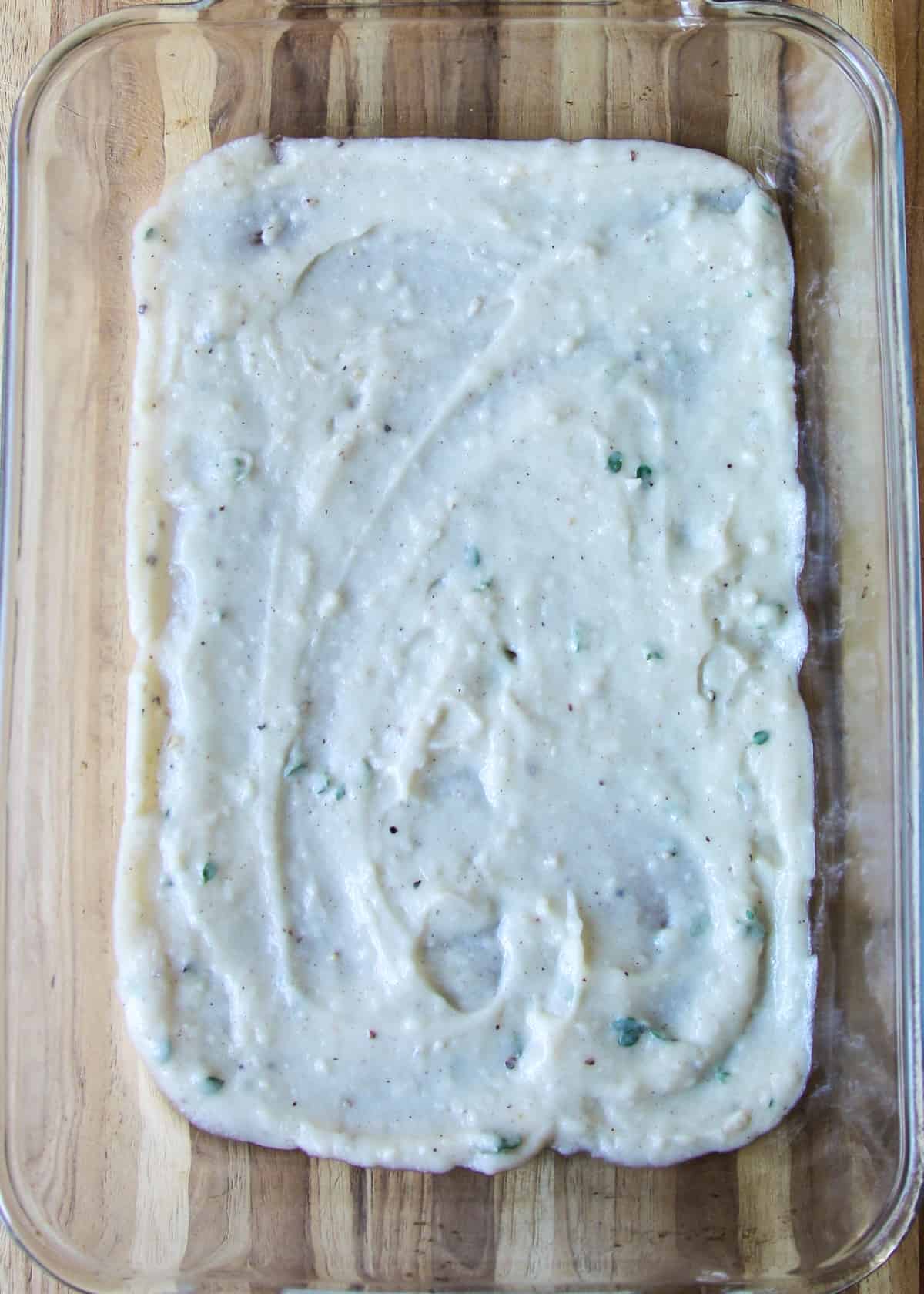 Bechamel sauce in a lasagna pan.