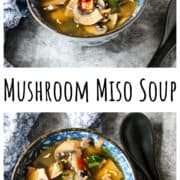 Mushroom miso soup in a blue and white bowl on a stone countertop.