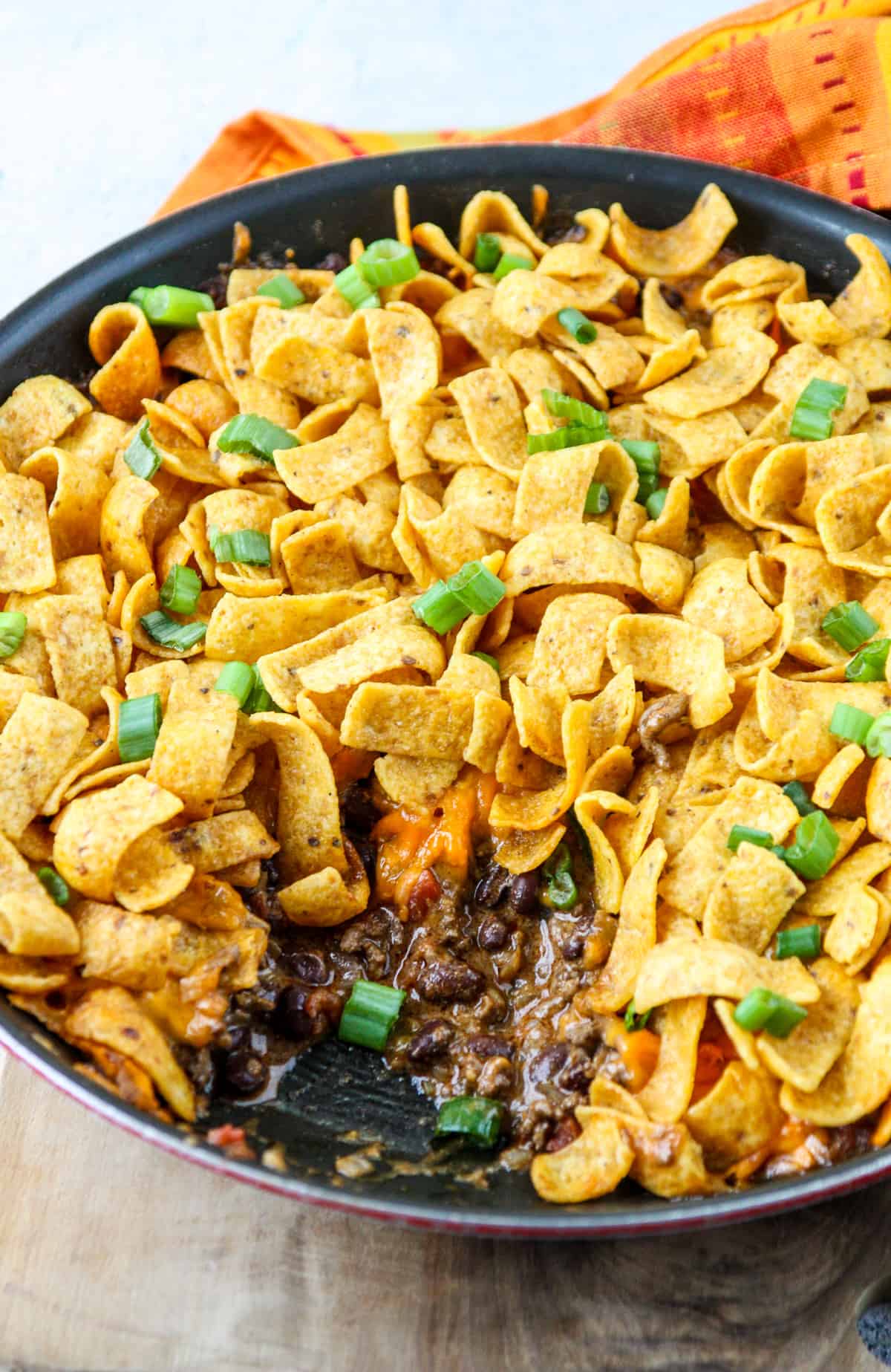 Baked walking taco casserole in a skillet.