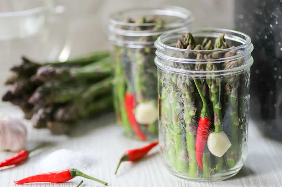 Two jars of pickled asparagus.