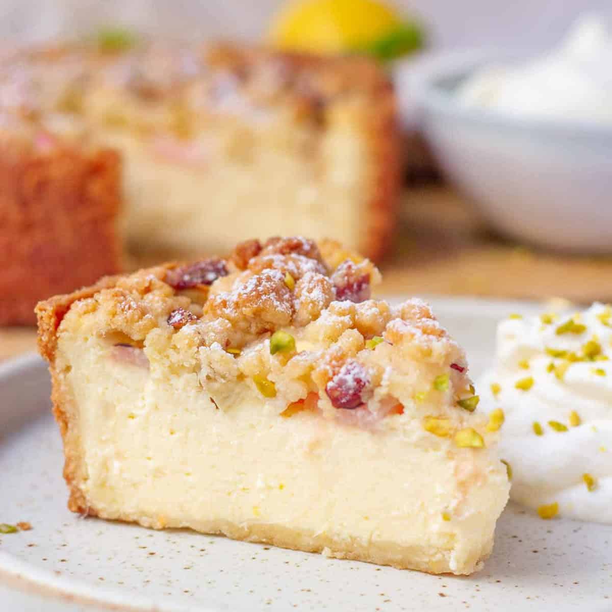 A slice of rhubarb cheesecake on a white plate.