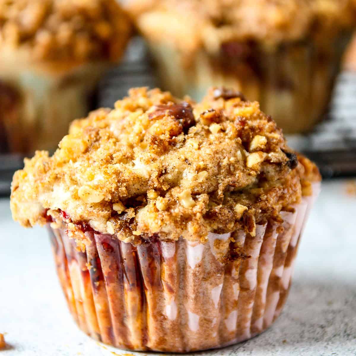 A streusel topped strawberry rhubarb muffin.