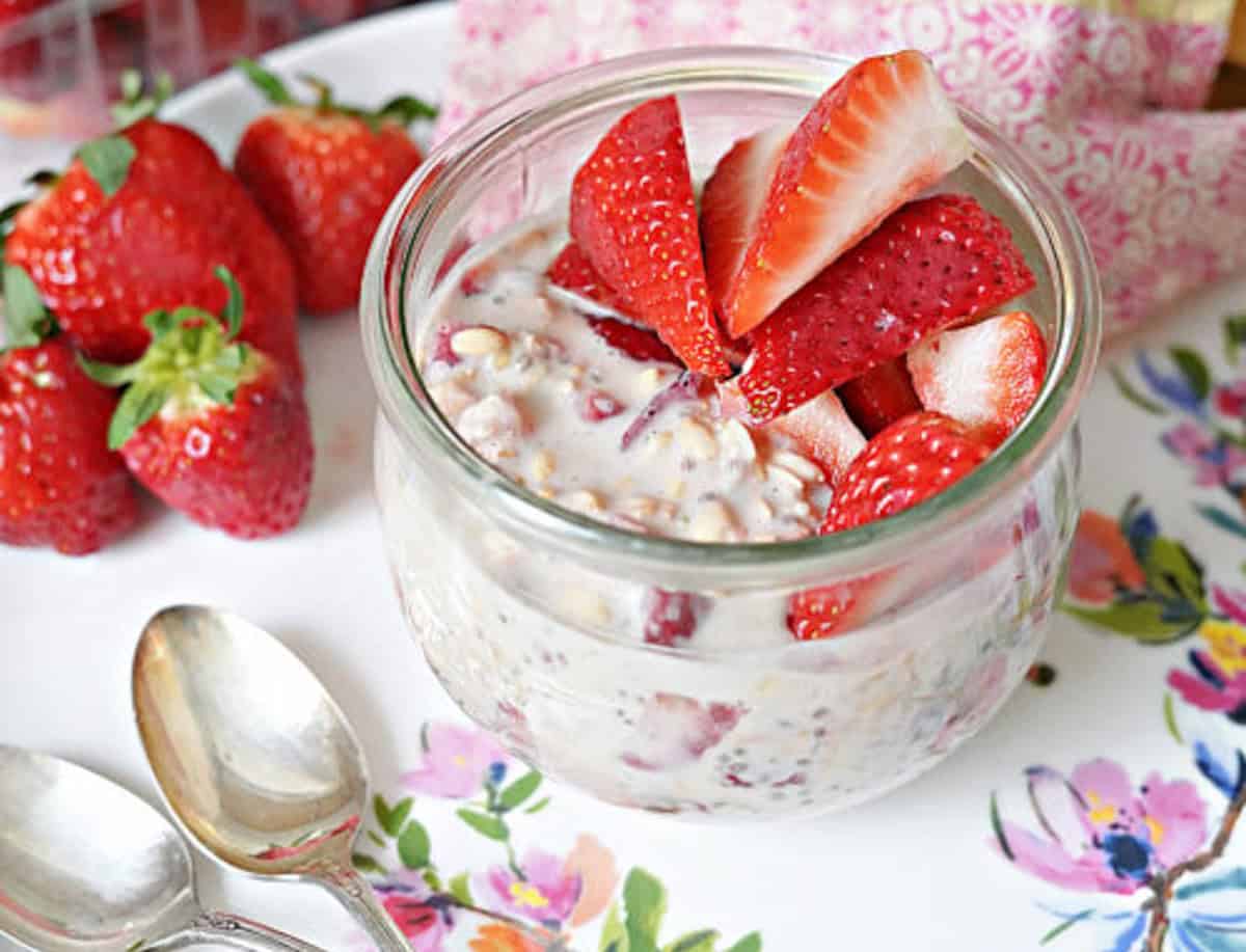 Overnight oats with strawberries in a glass jar.
