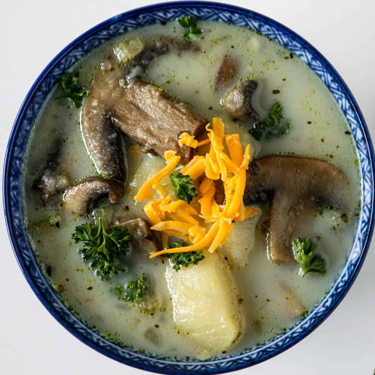 Potato mushroom soup in a blue bowl.