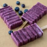 Blueberry popsicles on parchment paper.