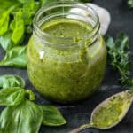Basil chimichurri sauce in a glass jar.