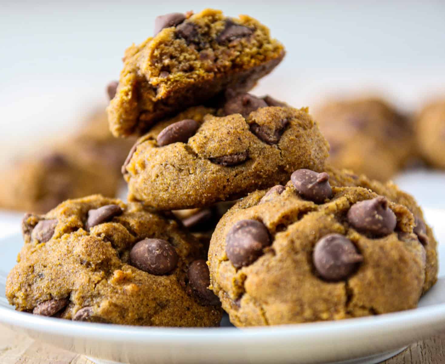 Gluten free pumpkin cookies stacked on a white plate.